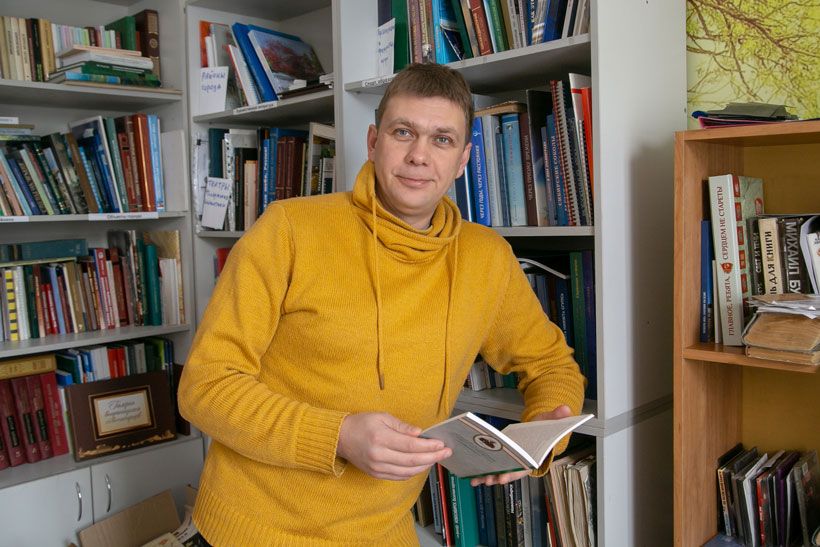 Экскурсовод Евгений Антропов с книгой в руках
