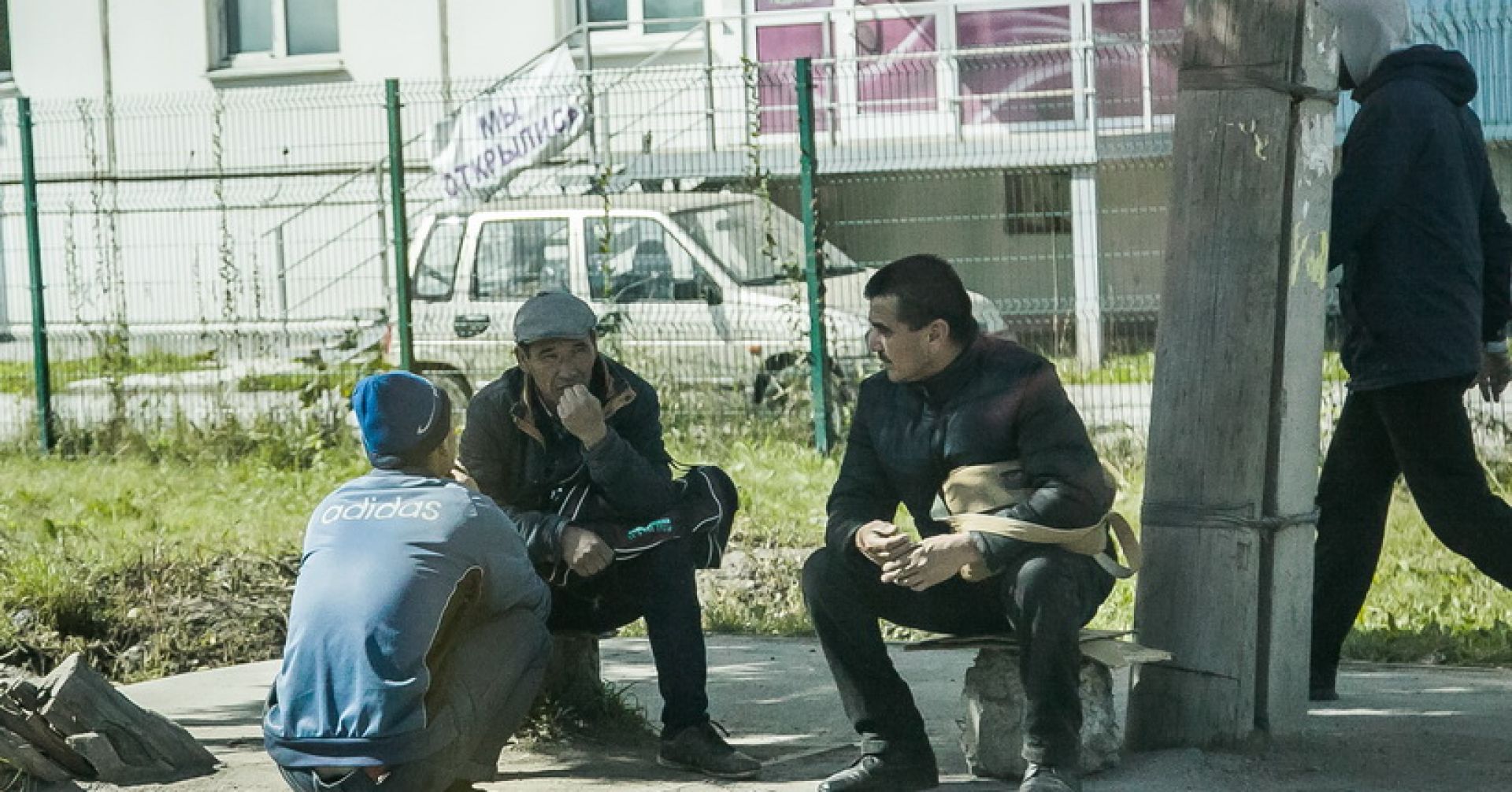 мигранты сидят на улице